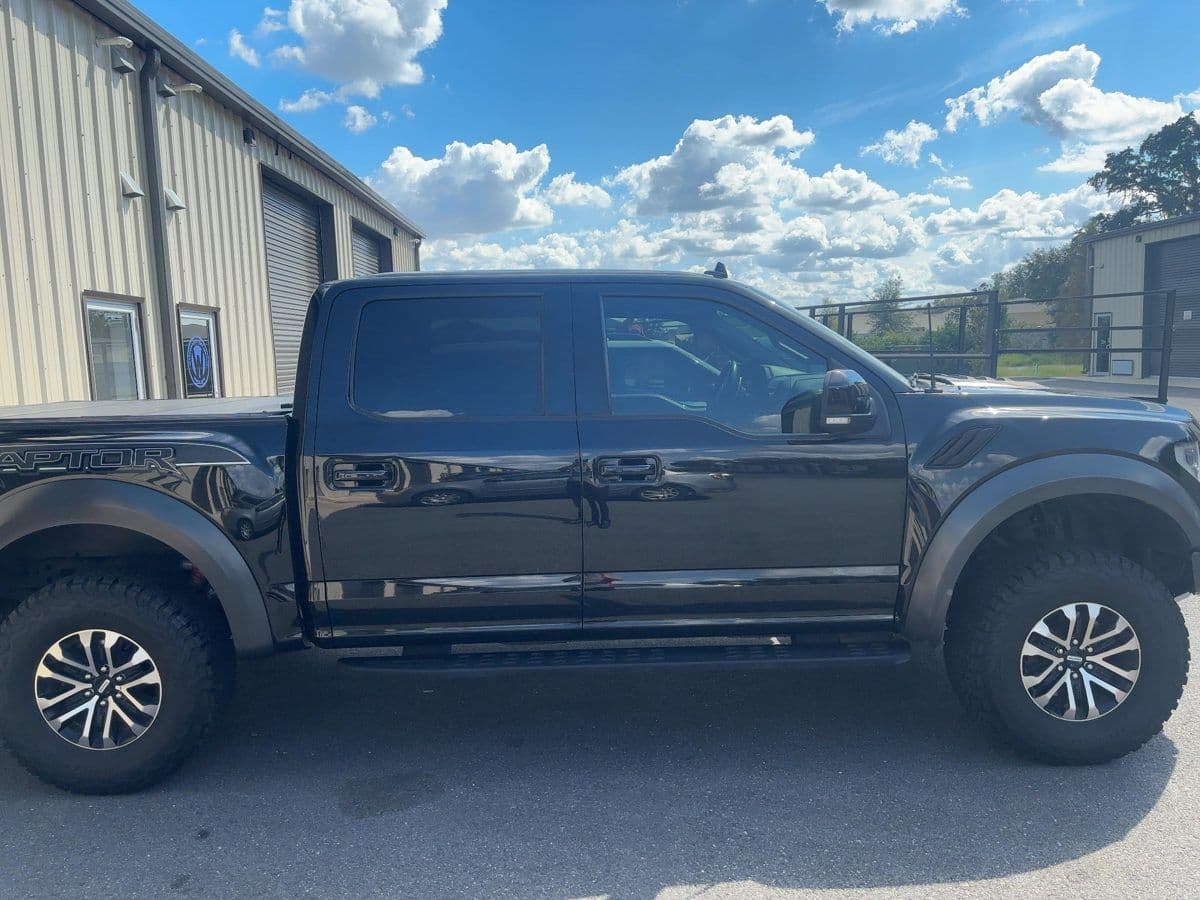 A black Ford F-150 with ceramic window tint