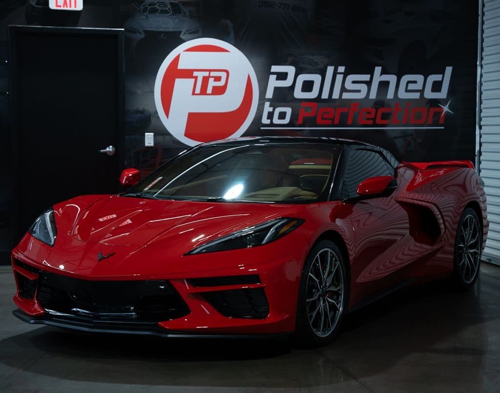 A red Corvette C8 in the Polished to Perfection studio