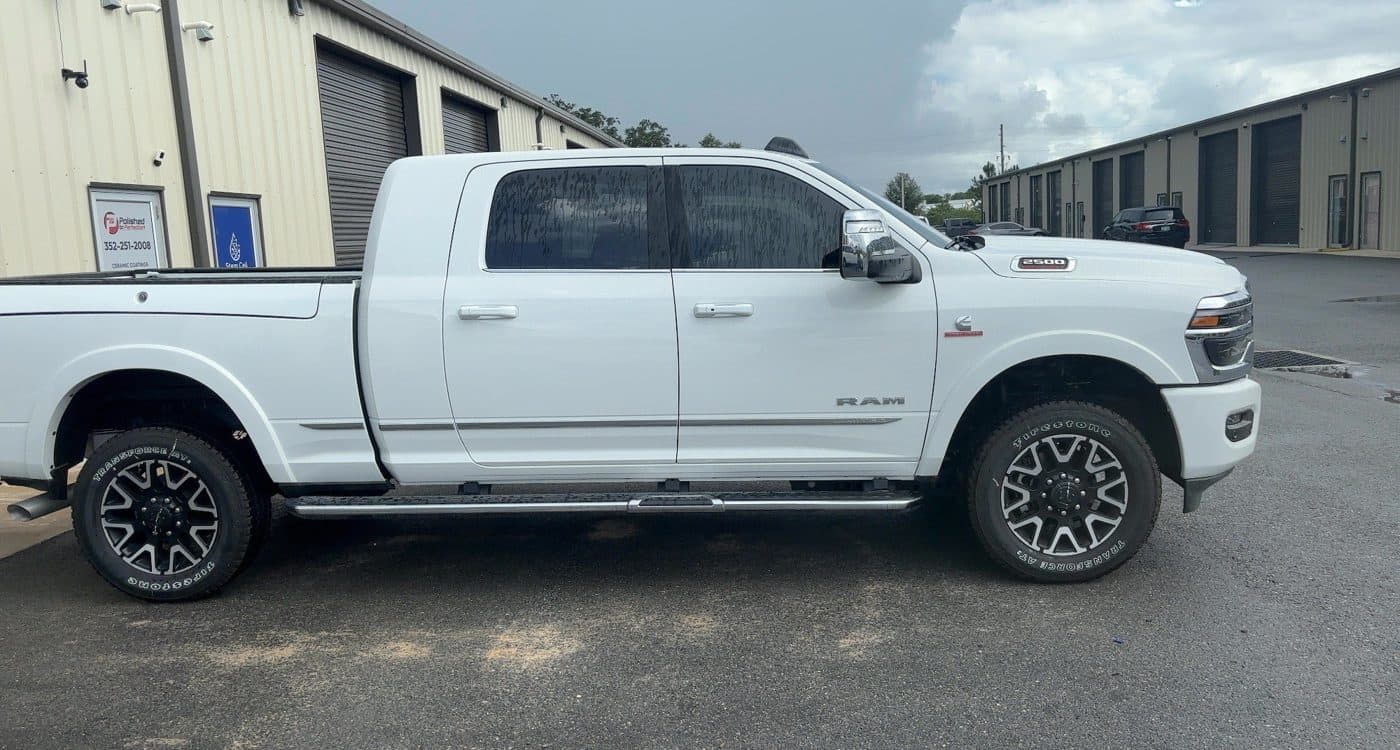 White Ram 2500 with ceramic window tint outside the shop
