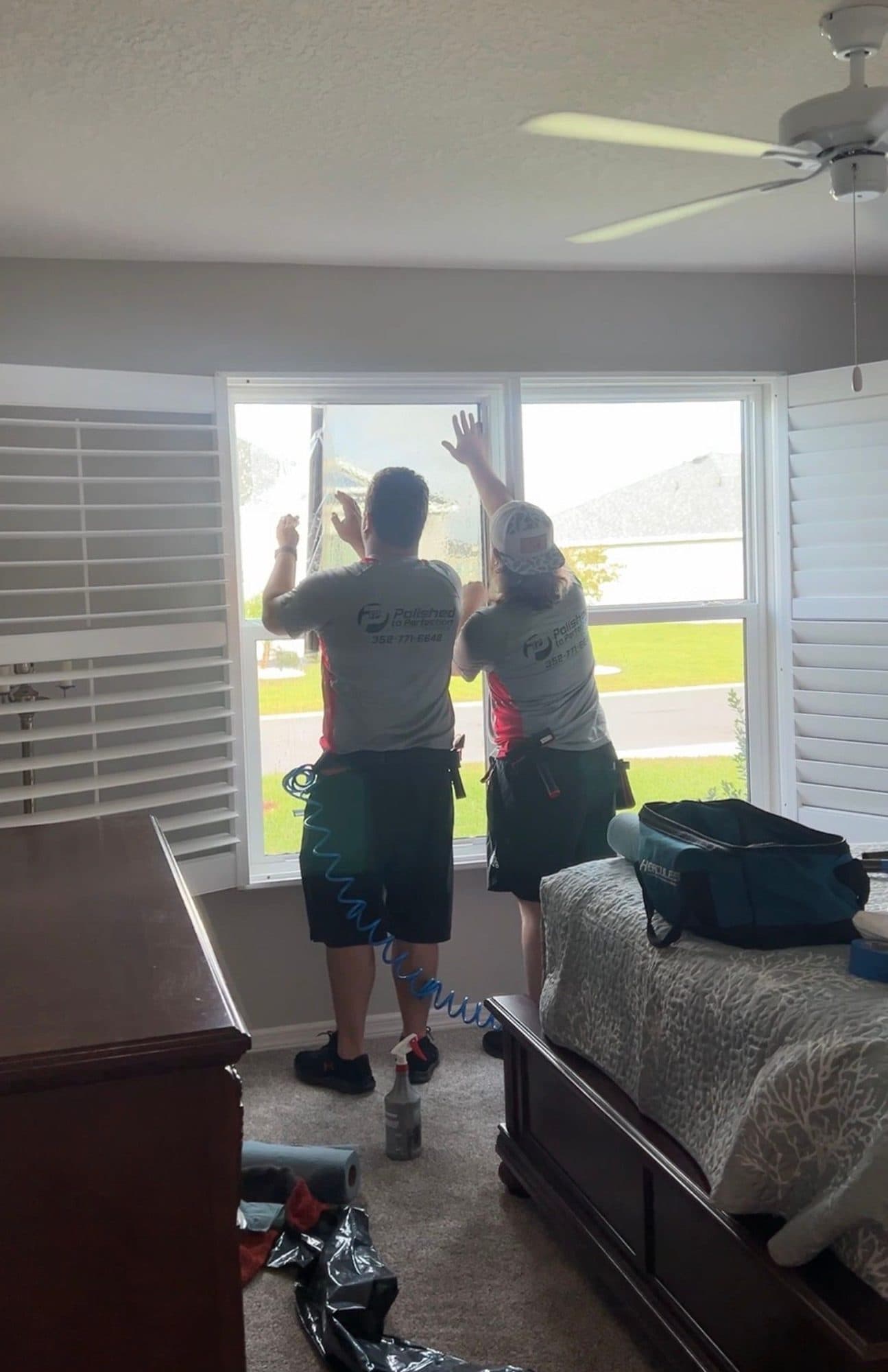 Crew installing window film in a bedroom
