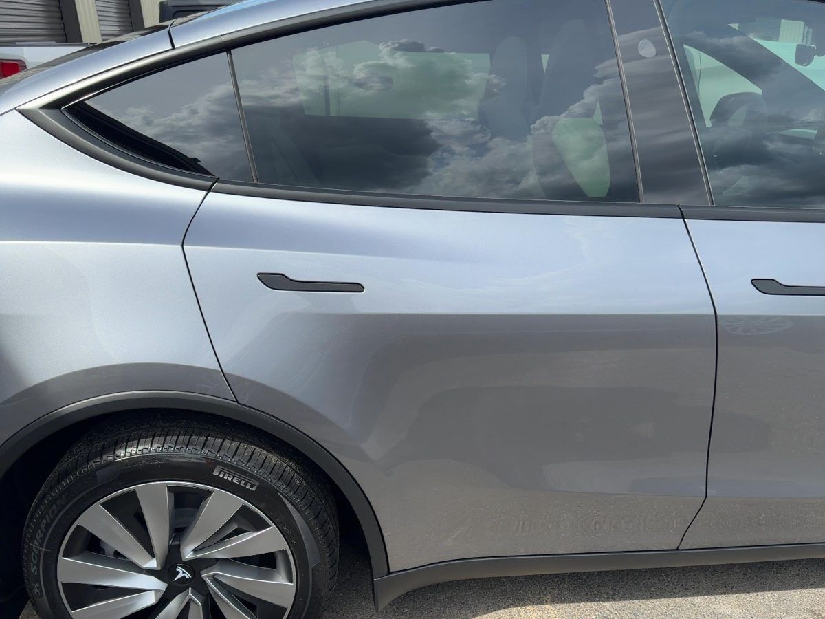 A gray Tesla Model Y with ceramic window tint
